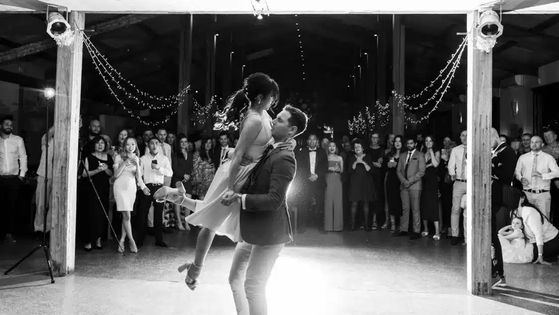 Bonnie and Matthew sharing their first dance surrounded by wedding guests
