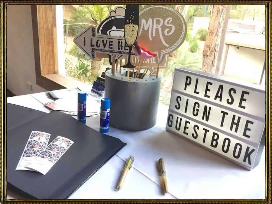 Glam Photobooths - Table with a Guestbook Metallic Markers and a Sign The Guestbook Sign