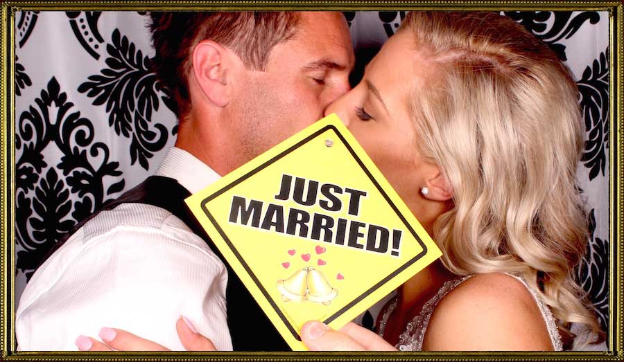 Just Married Do Not Disturb - Newlyweds having a not-so-intimate moment in a photo booth.