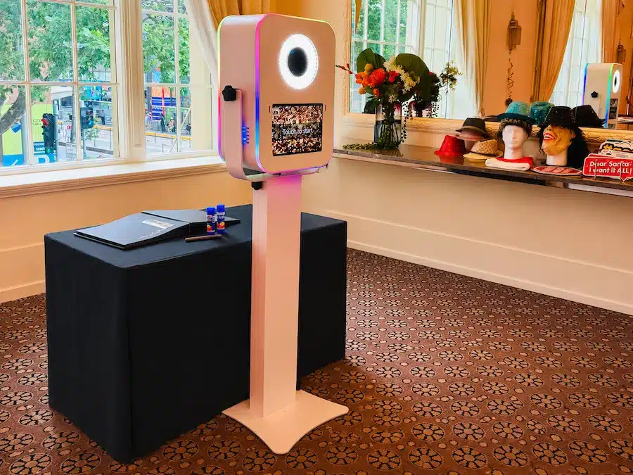 DSLR photo booth setup at a Melbourne Christmas party with instant prints, guest book and festive props.