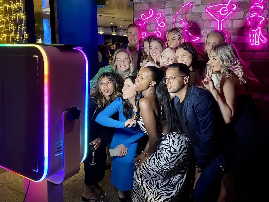 Guests posing for a group selfie using the Glam Photobooths Selfie Station at a Melbourne event.